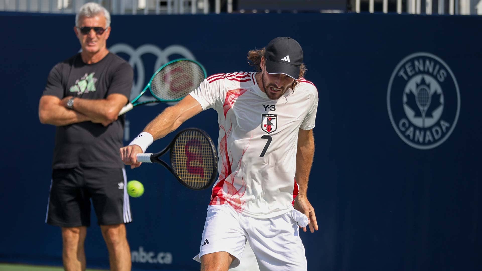 Stefanos Tsitsipas practises in Toronto on Friday, with father Apostolos Tsitsipas looking on.